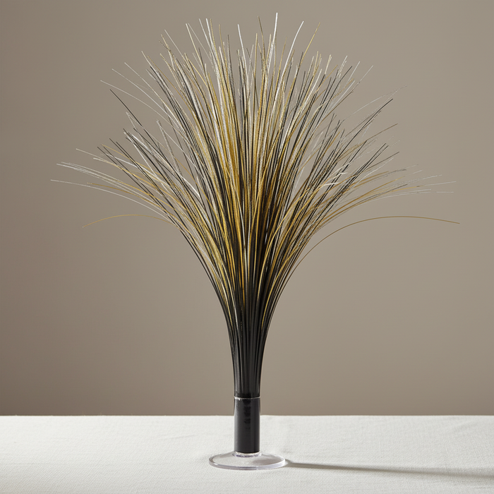 Black and gold metallic spray centrepiece on a white-clothed table