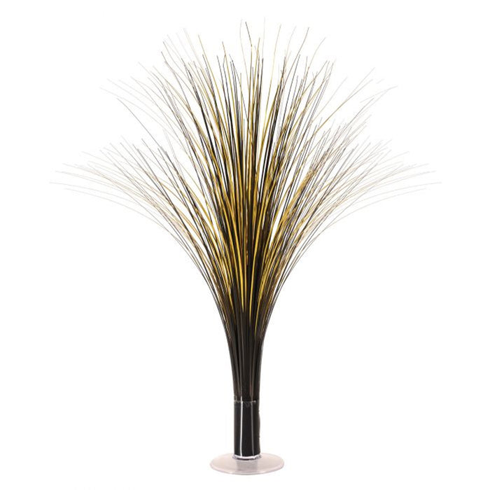 A black and gold metallic spray centerpiece with a feathery appearance, standing in a clear vase.