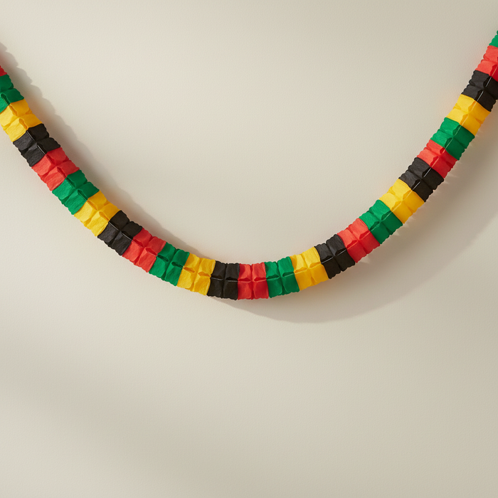 Black yellow green red tissue paper garland draped on wall