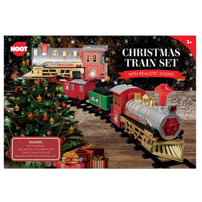 Hoot Christmas train set packaging with a train, tree, and presents on a wooden floor.