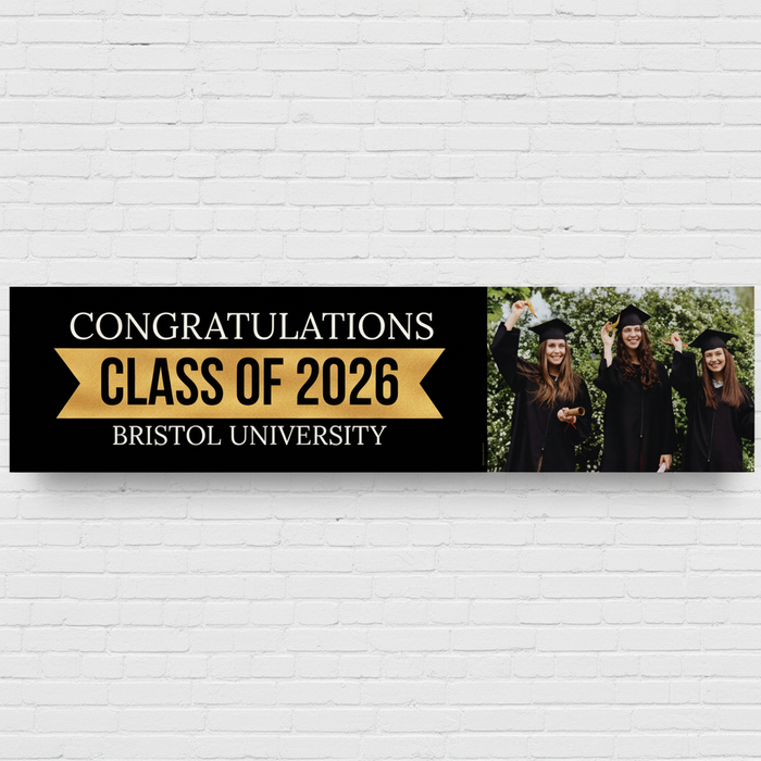 Graduation Banner on White Brick Wall