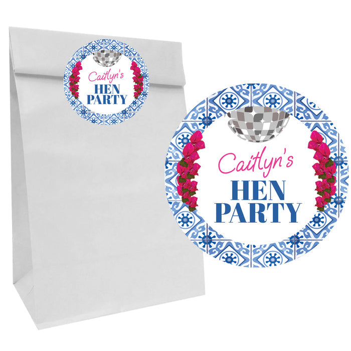 White gift bag with 'Caitlyn's Hen Party' label featuring floral and checkered design.