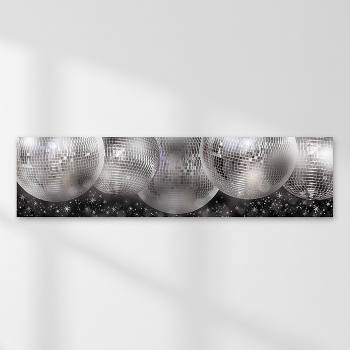 Silver disco-ball banner on a white wall