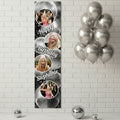 Personalized birthday banner with photos and balloons against a white brick wall.