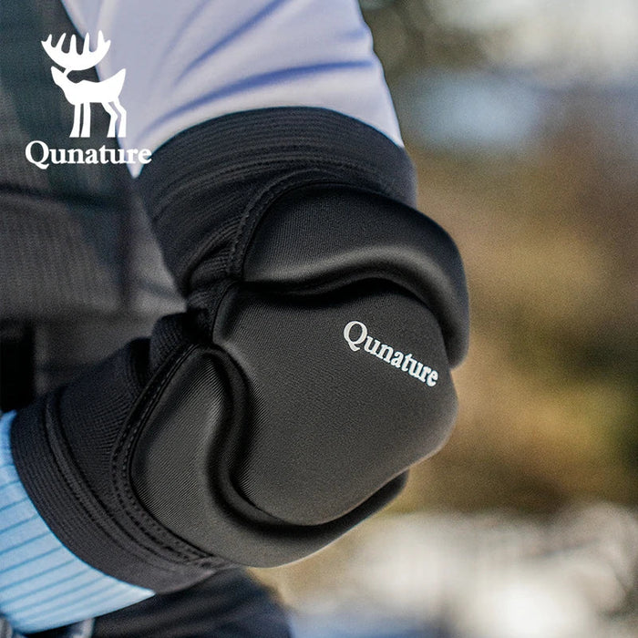 A person wearing a pair of black elbow pads