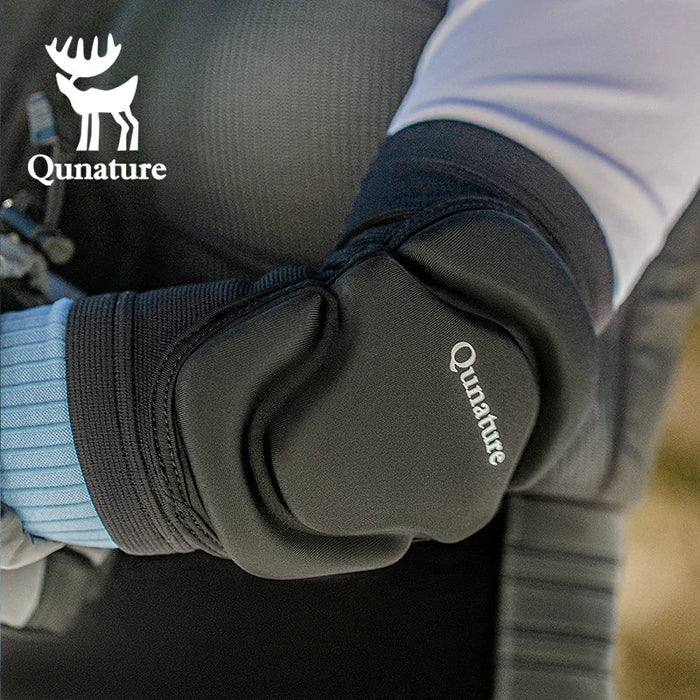 A person wearing a pair of black elbow pads