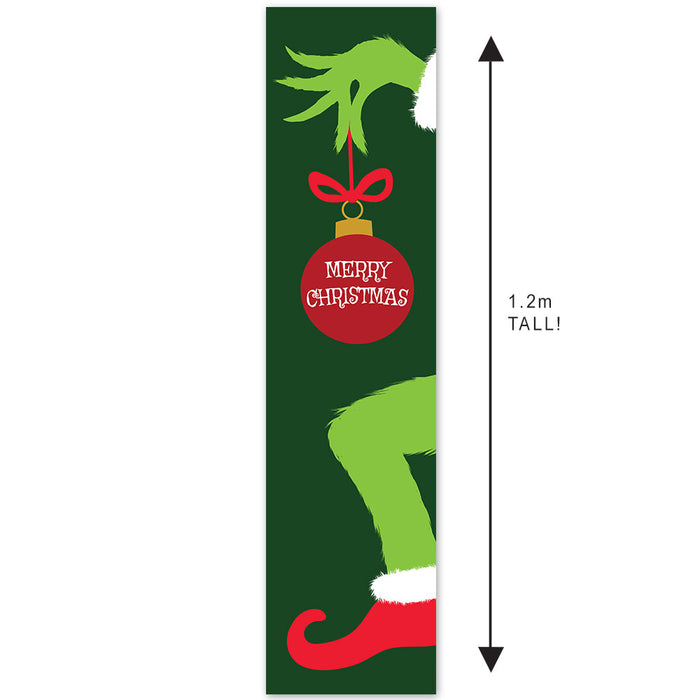 Decorative banner with an elf hand holding a Christmas ornament on a green background.