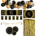 Collection of New Year's Eve decorations including balloons, banners, and fans on a white background.