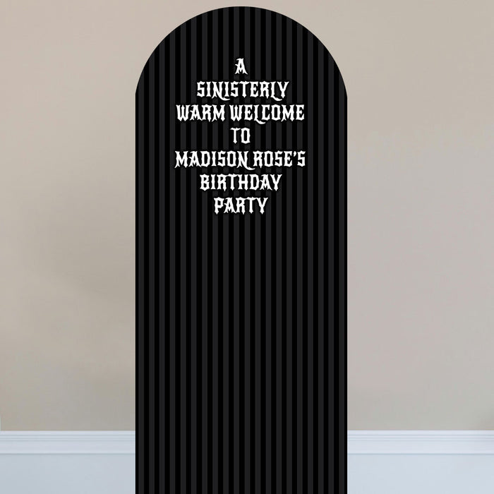 Black arch with white text on a beige wall