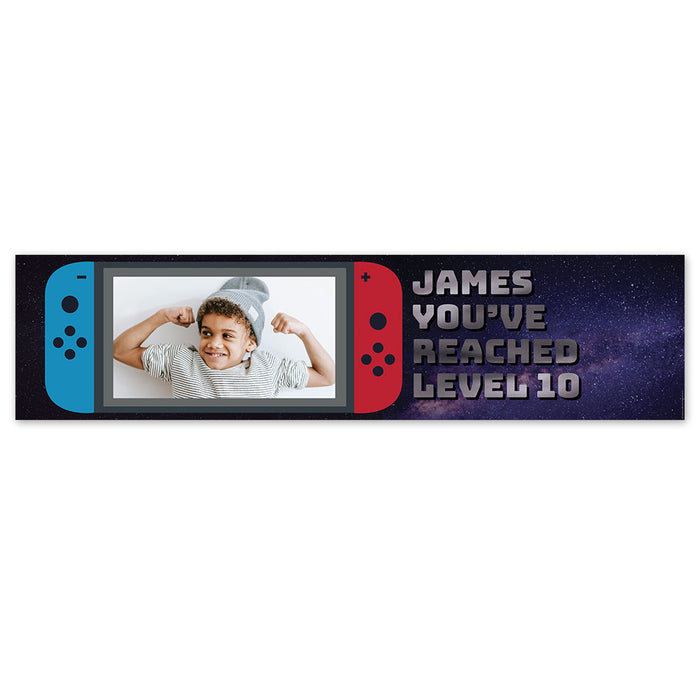A personalised banner with a gaming theme, featuring a photo upload section, text that reads 'JAMES YOU'VE REACHED LEVEL 10', and a representation of a gaming console on the sides.