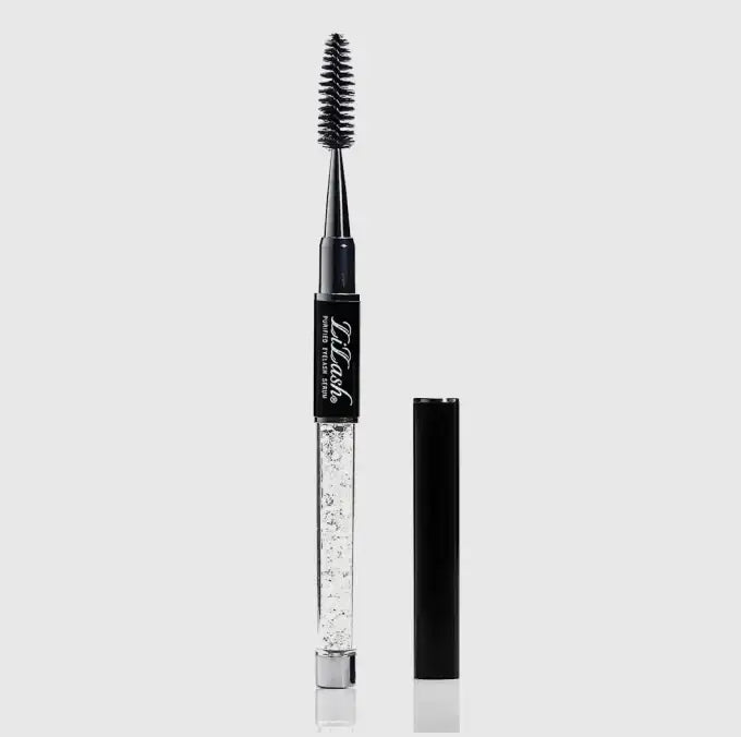 LiLash beauty serum with spoolie brush and applicator tube on a plain light background