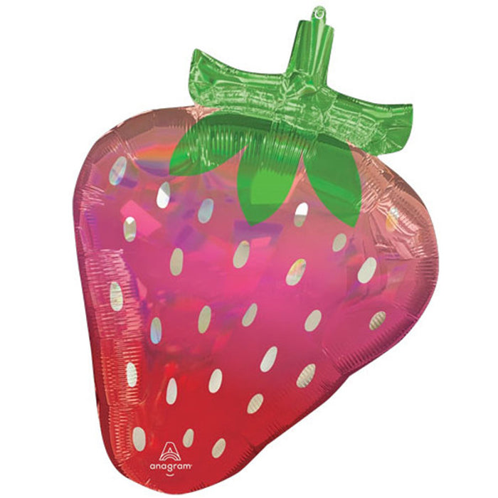 A foil balloon in the shape of a strawberry with a vibrant red and pink iridescent hue, with green leaf detail on top.