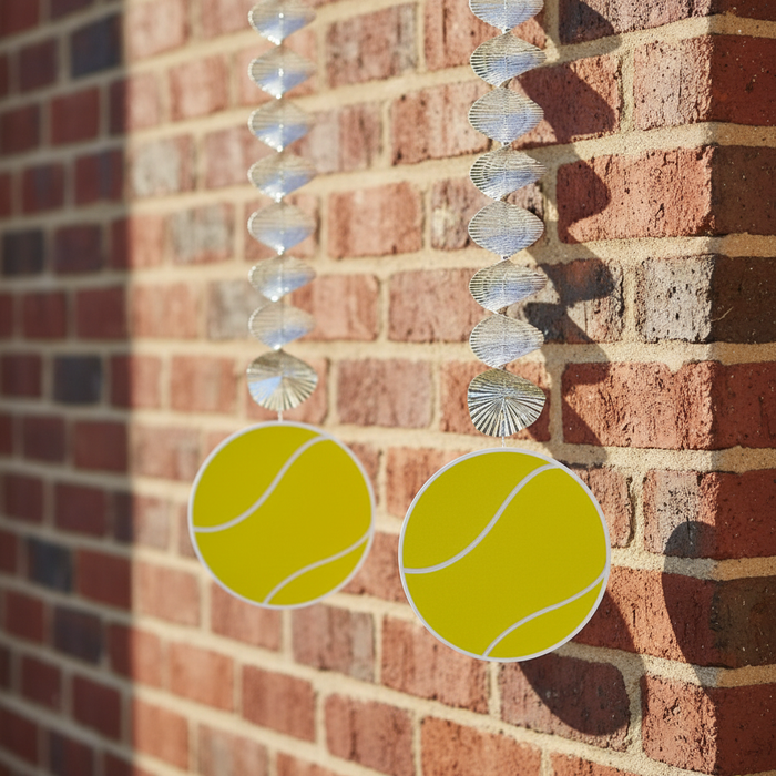 Tennis Ball Danglers on Red Brick Wall