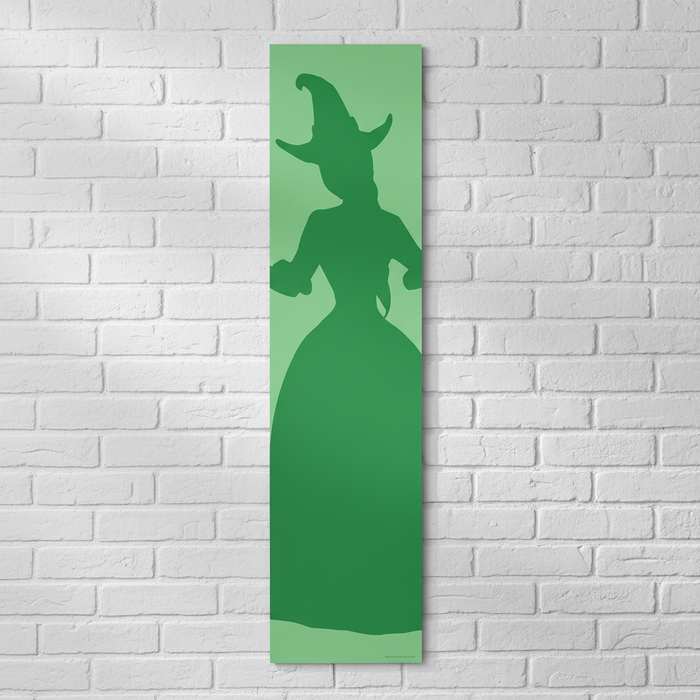 Witches of Oz Green Banner on White Brick Wall